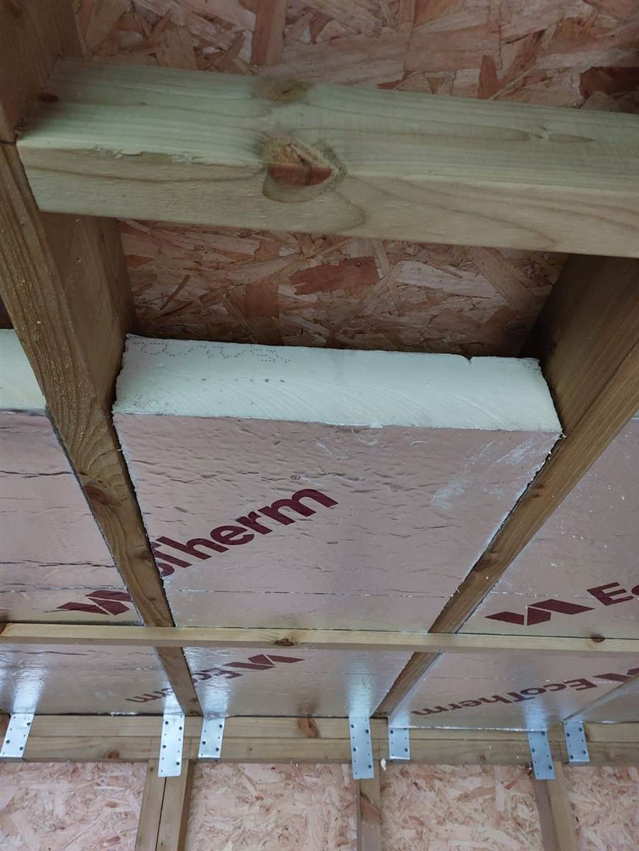Completed structural shell wrapped in Protect VP400 breather membrane, flat roof fitted, door opening visible